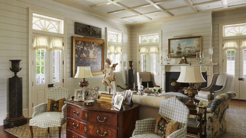 Elegant colonial living room featuring traditional furniture and vintage artwork.
