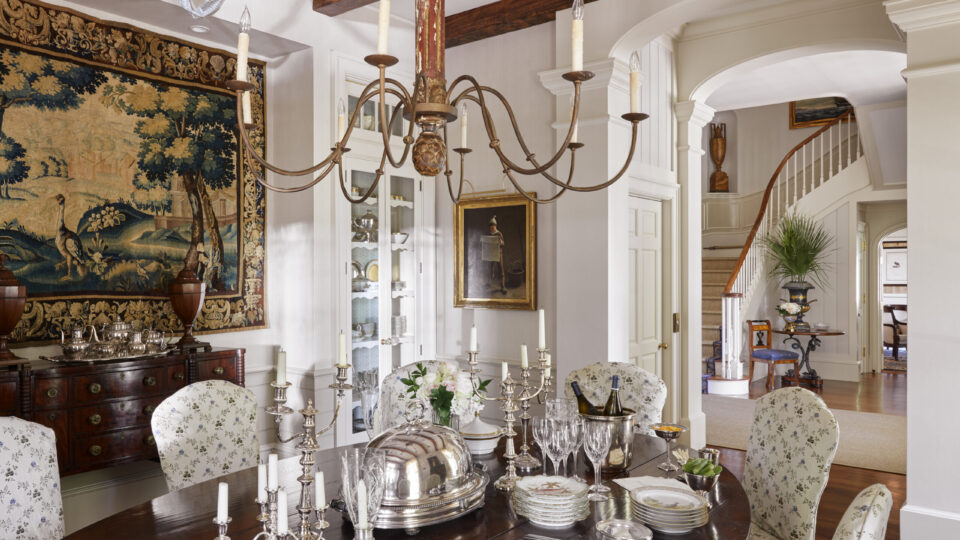 Charming traditional dining room featuring vintage decor, ornate chandelier, and elegant table setti.